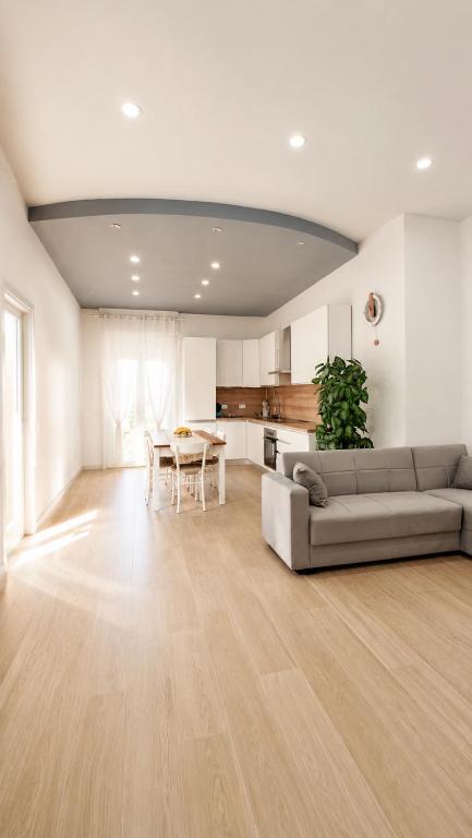 a living room with a couch and a table at In DhomeU Tua - Free Wifi & Private Garden in Selargius