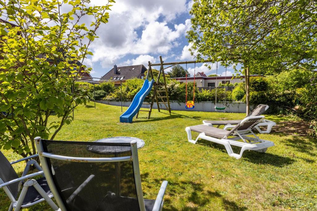 a playground with two chairs and a slide at Luv Lee Duhnen 06 in Cuxhaven
