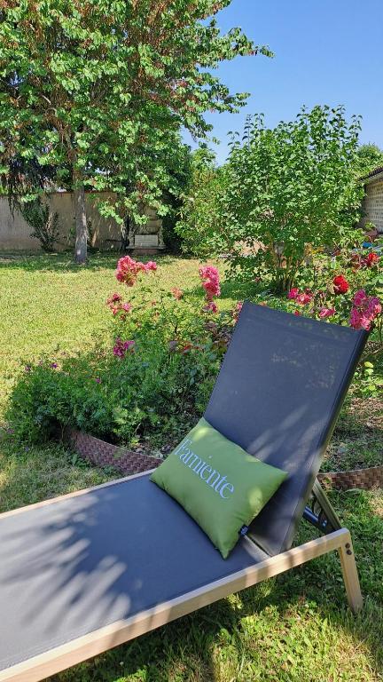 a lounge chair with a pillow sitting in a yard at Chez tatie Jacqueline in Albi
