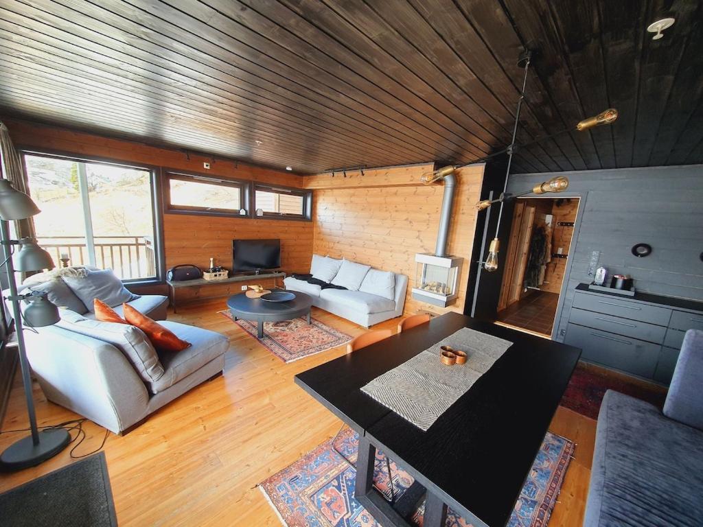 a living room with a couch and a table at Beautiful apartment in Sinnes E12 in Dirdal