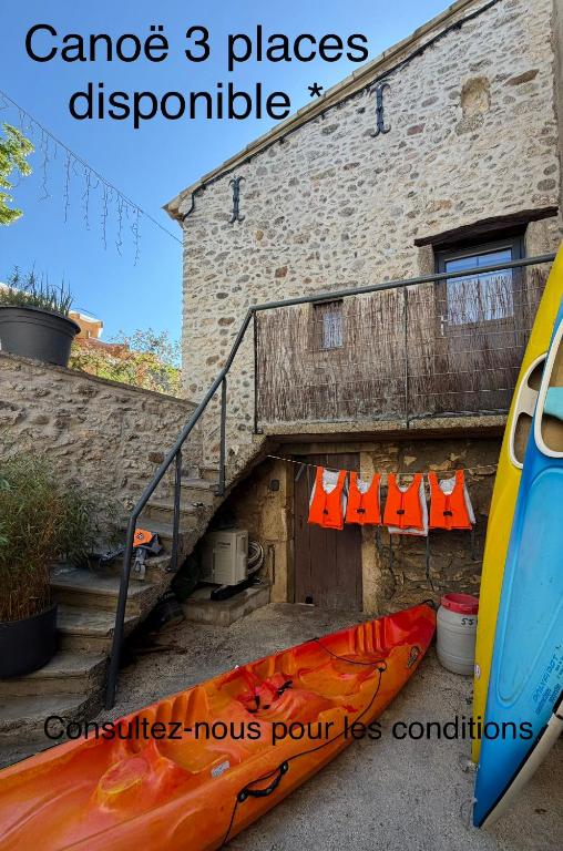 ein Gebäude mit einer Treppe und zwei Kajaks daneben in der Unterkunft Lézardéchois in Saint-Martin-dʼArdèche