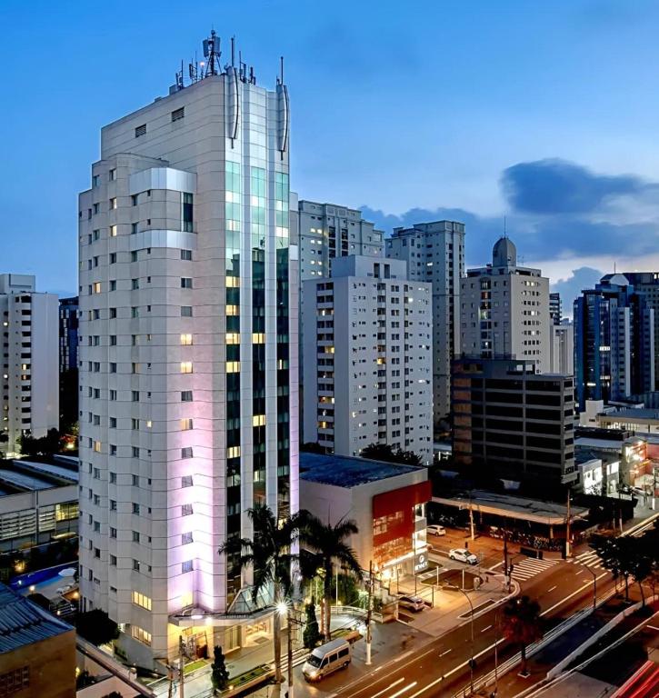 a tall white building in a city with traffic at Intercity São Paulo Ibirapuera in São Paulo
