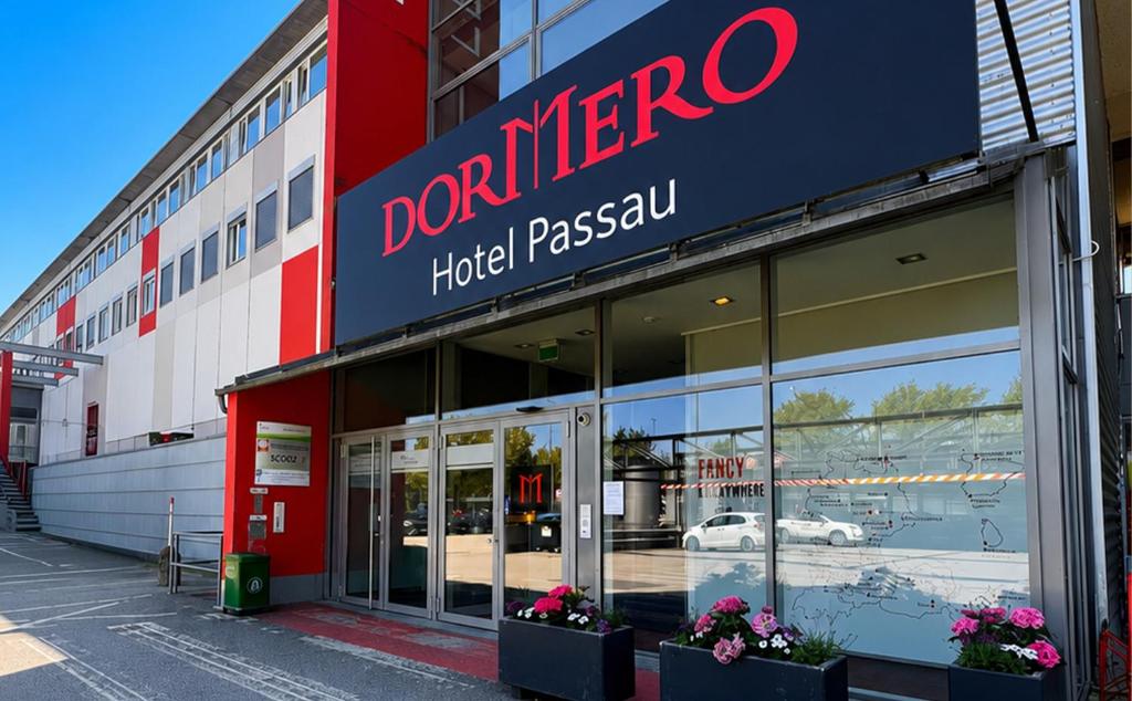 a store with a sign on the side of a building at DORMERO Express Hotel Passau in Passau