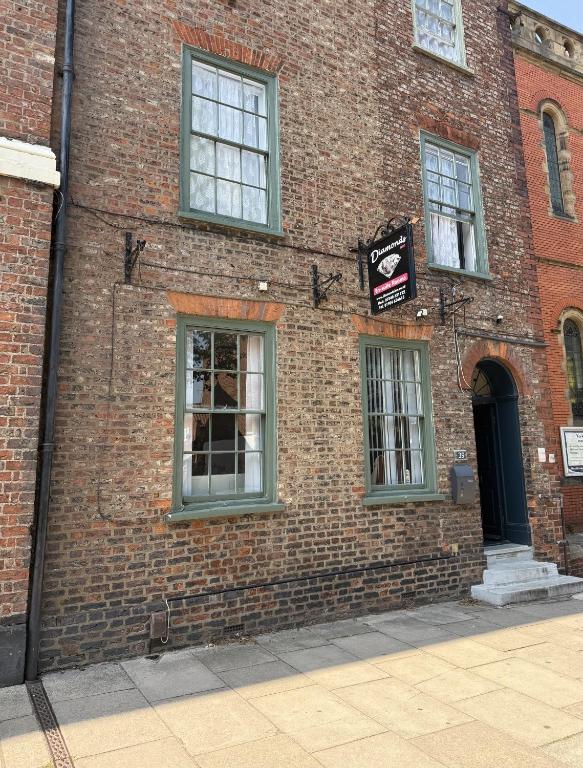 a brick building with windows and a sign on it at Diamonds Inn Ltd in York