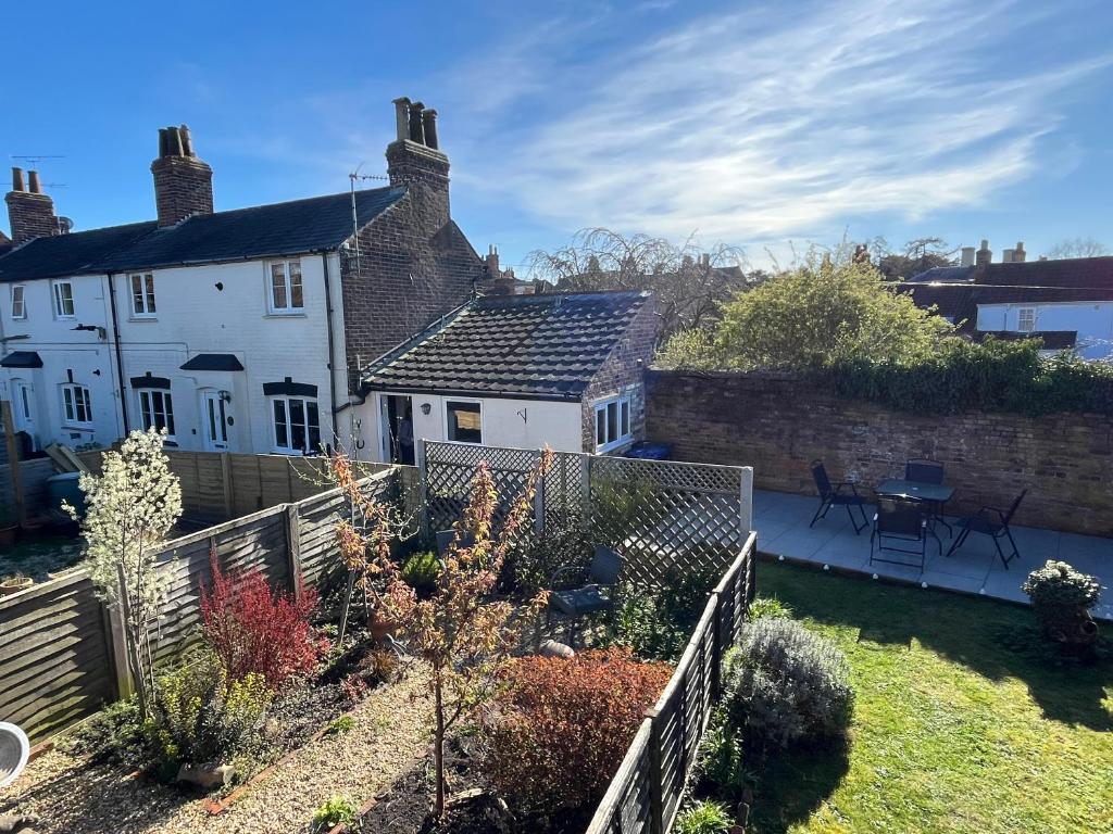 a house with a garden and a fence at Copper Cottage in Devizes