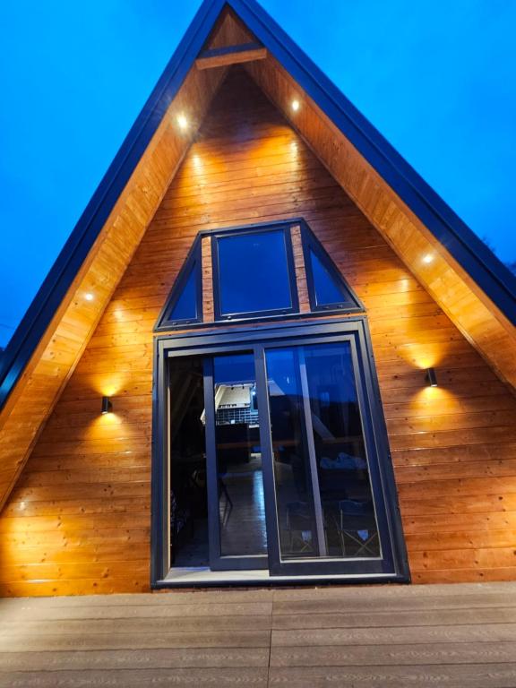 a house with a gambrel roof with a window at Moonrise house Rudnik in Rudnik