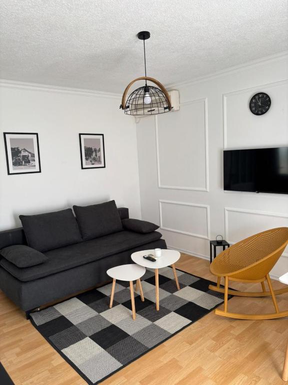 a living room with a couch and a table at Apartmani Daria in Ljubuški