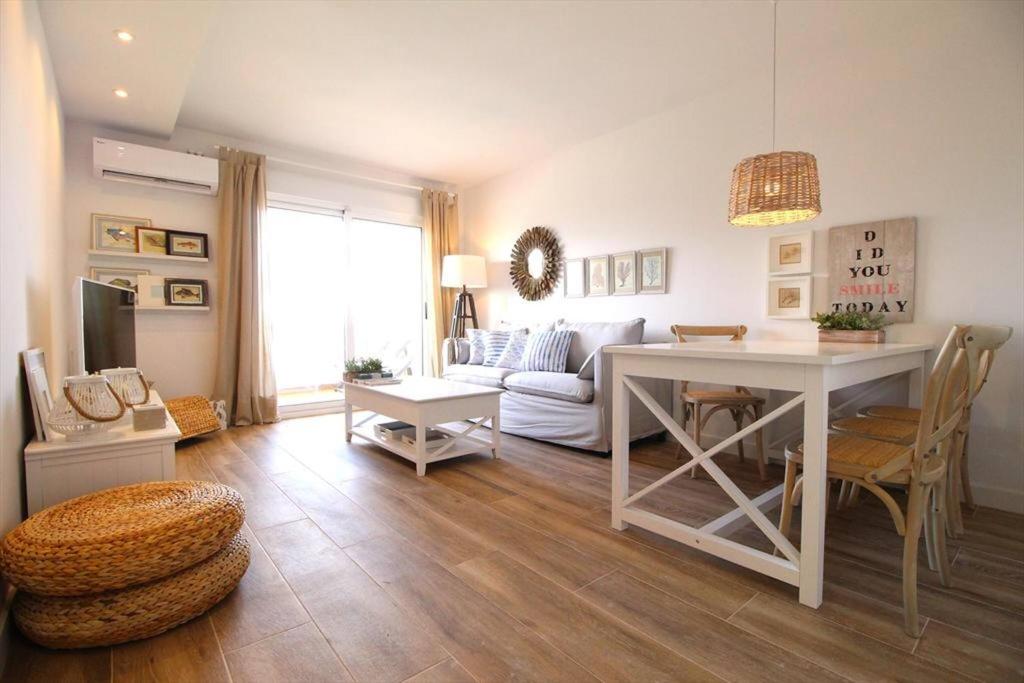 a living room with a white table and a couch at Santa Ana 22 by homeprive in El Verger