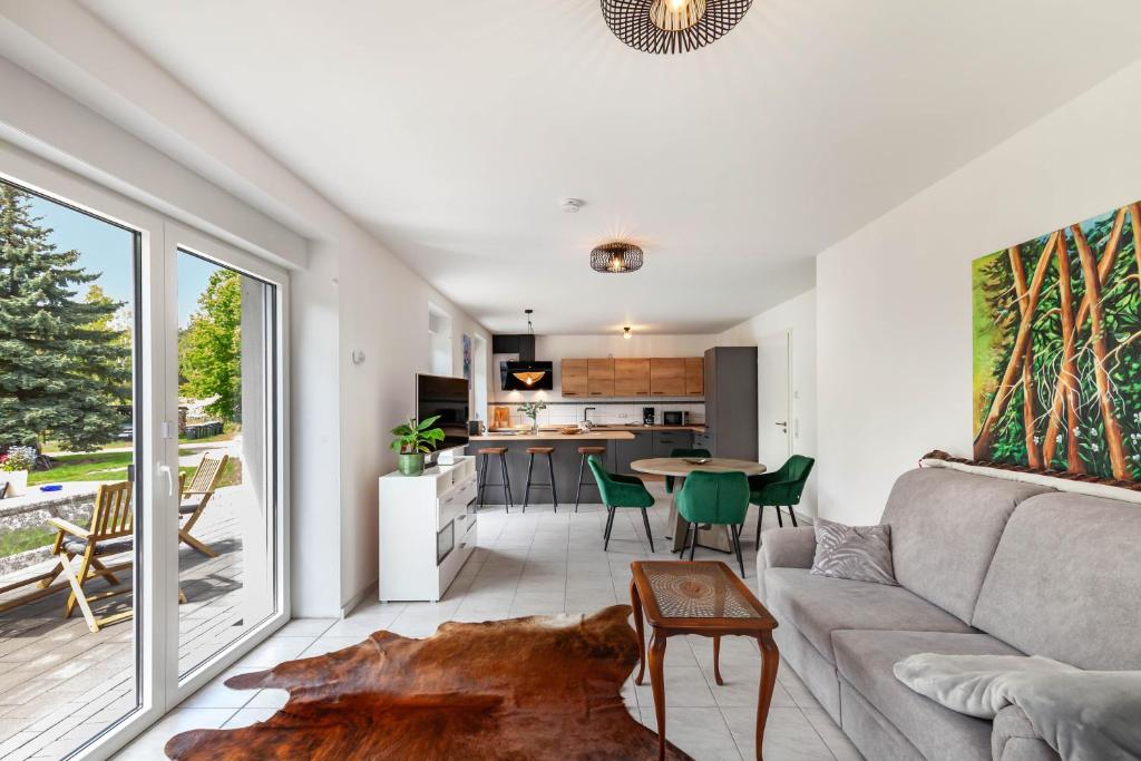 a living room with a couch and a table at Ferienwohnung Seeglück in Lauchhammer