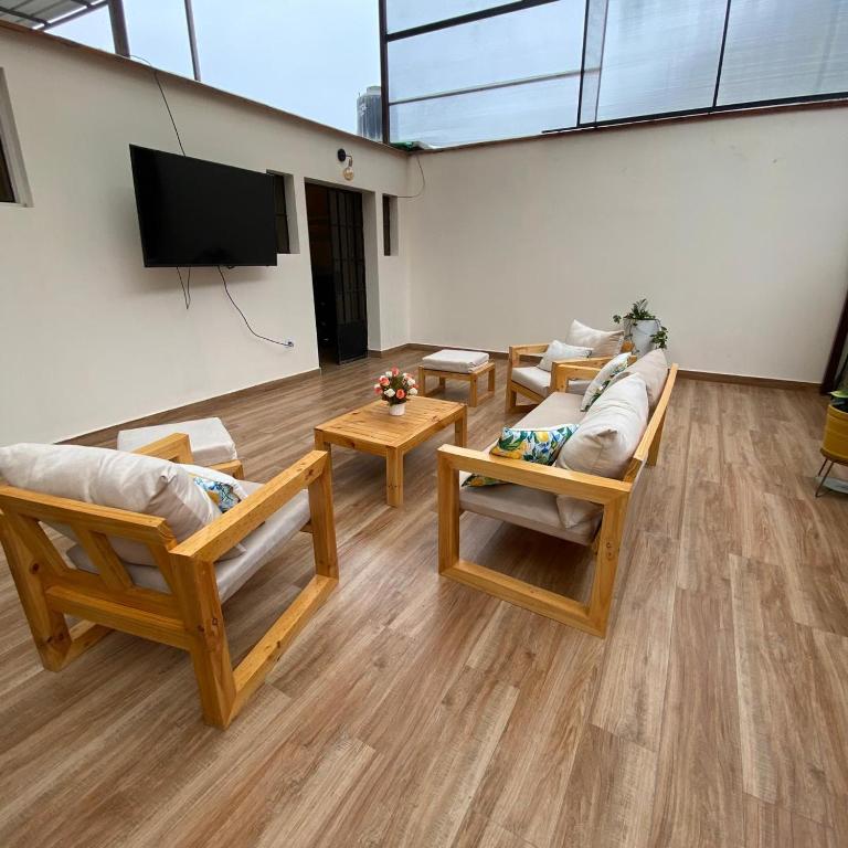 a living room with couches and a flat screen tv at La casa del cuadro in Lima