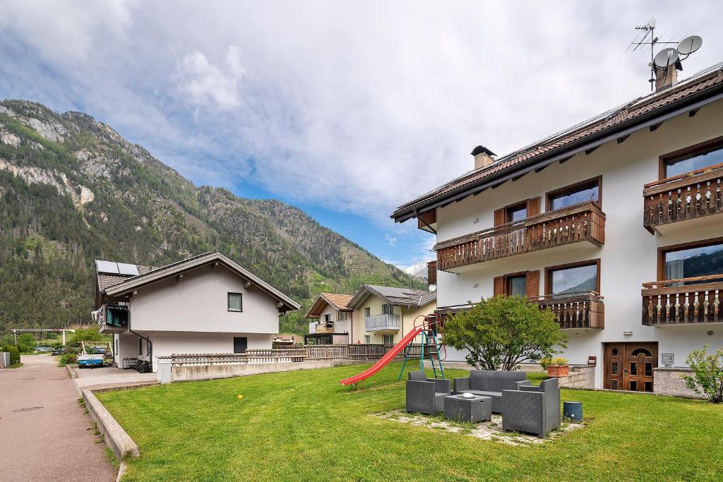 a house with a red slide in the yard at Casa Morsich in Predazzo