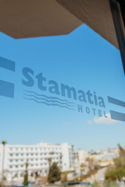 a sign for a hotel in front of a building at Stamatia Hotel in Ayia Napa