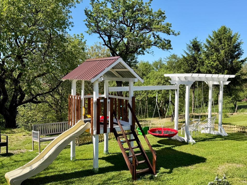 a playground with a slide and a gazebo at Casa Cenţiu in Bran