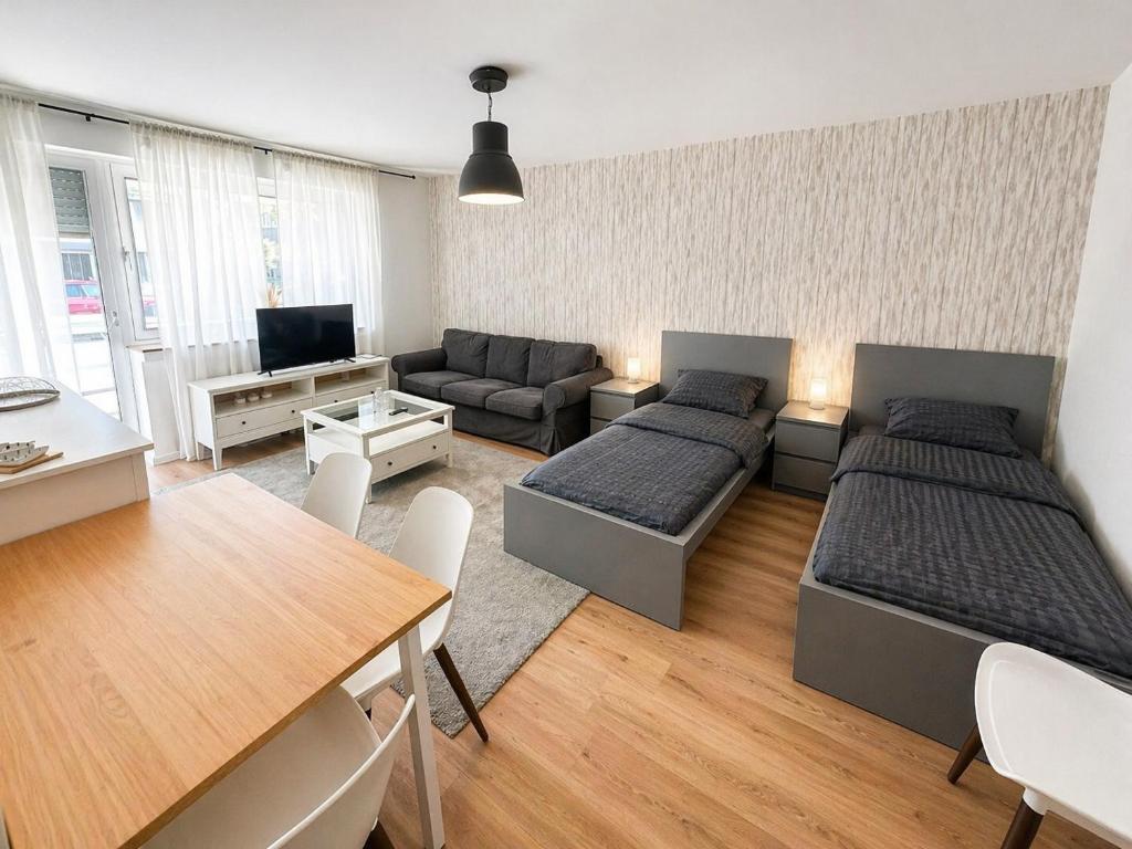 a living room with two beds and a table at Pulheim Living 5 in Pulheim