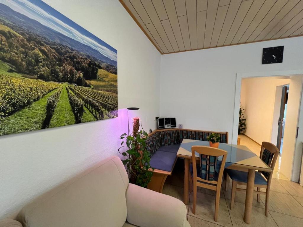 a living room with a table and a painting on the wall at Ferienwohnung Stani in Leibnitz