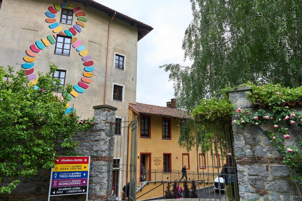 a building with a kite hanging off the side of it at Hotel Cittadellarte in Biella