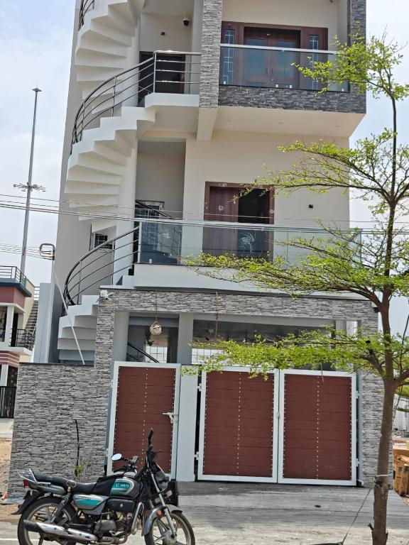 a motorcycle parked in front of a building at Sathya Bay in Marakkānam