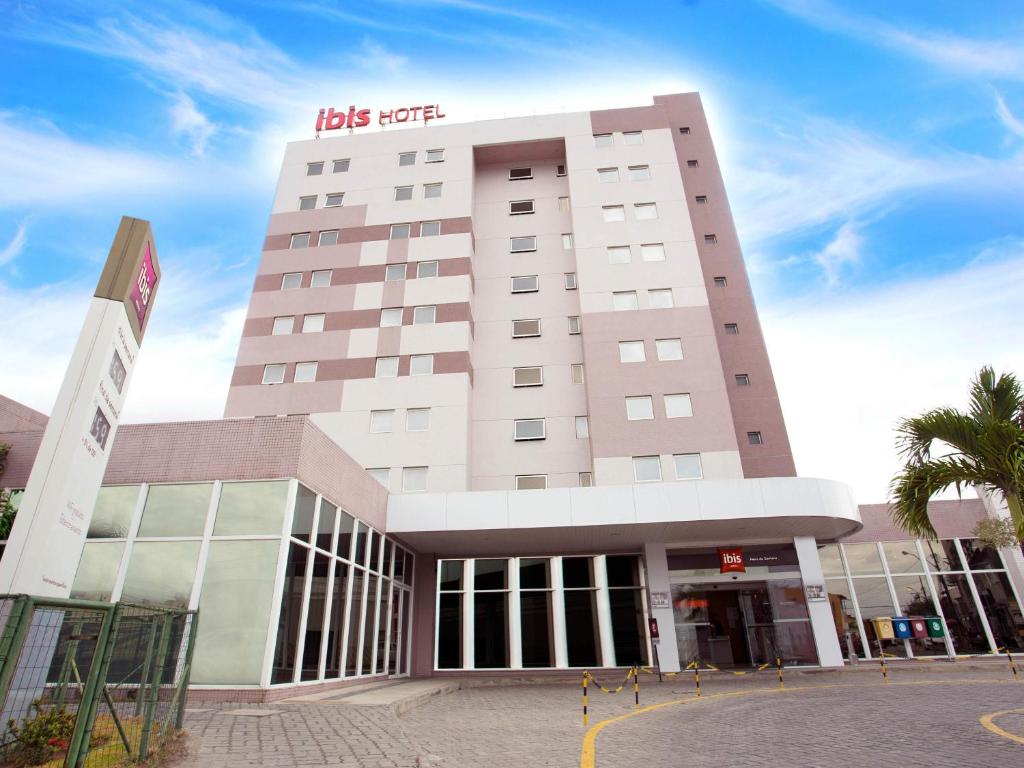 a large building with a sign on top of it at ibis Feira de Santana in Feira de Santana