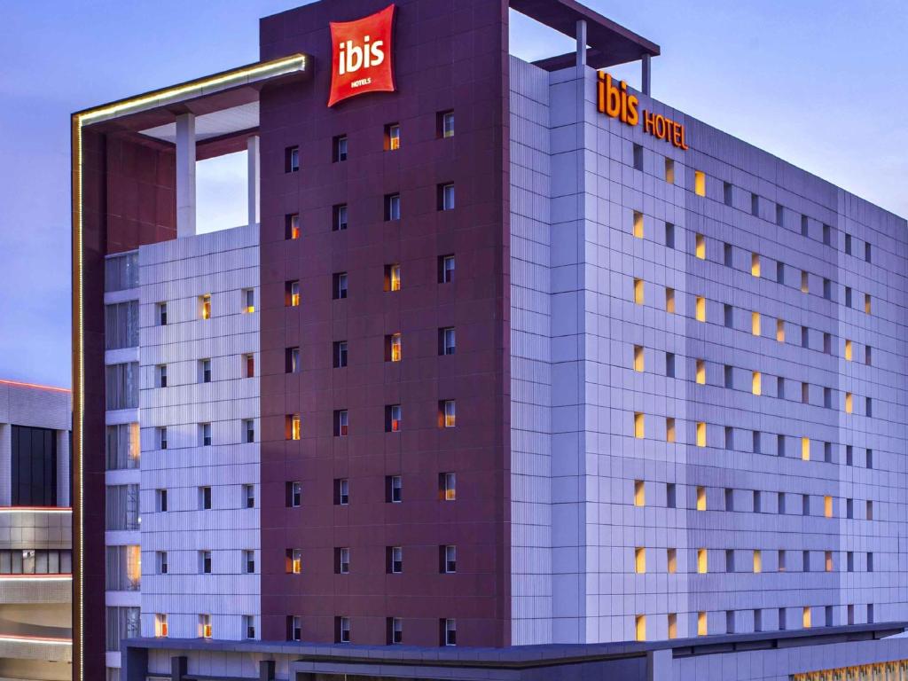 a building with a ups sign on the side of it at Ibis Surabaya City Center in Surabaya