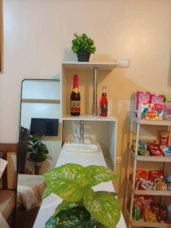 a bathroom with a sink with two bottles and a plant at New Centrio Tower Lovely Studio adj Ayala CDO in Cagayan de Oro
