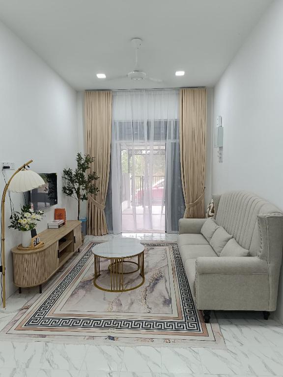 a living room with a couch and a coffee table at D'Berang Rumah Singgah in Kuala Berang