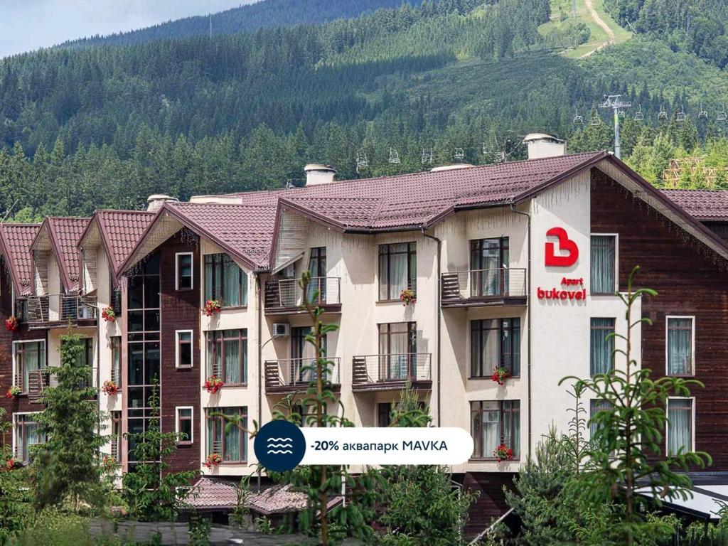 a hotel with a sign in front of it at Bukovel Apart in Bukovel