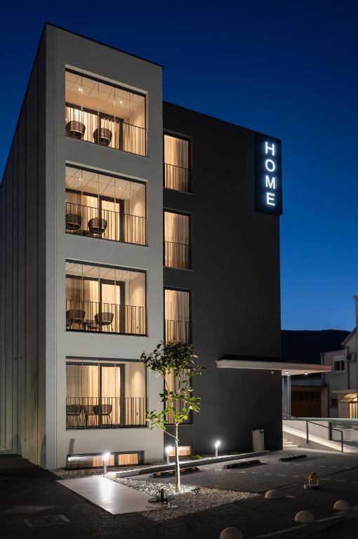 a building with a sign on the side of it at Home apartments in Mostar