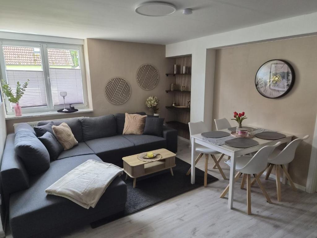 a living room with a blue couch and a table at Schöne Ferienwohnung nähe Geiseltalsee in Bad Lauchstädt