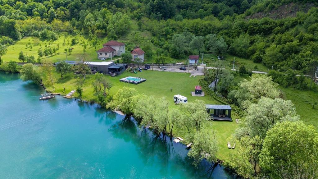 an aerial view of a house next to a river at Una Meryland Rooms & Bungalow in Kulen Vakuf