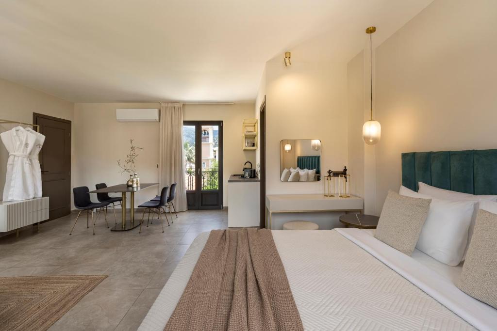 a hotel room with a large bed and a desk at KANTADA central suite in Argostoli
