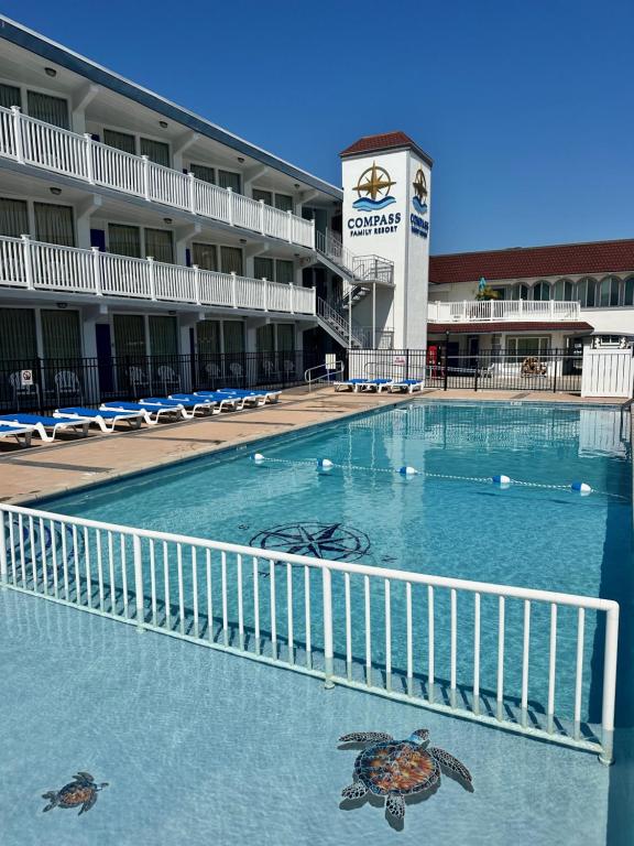 a swimming pool in front of a hotel at Compass Family Resort in Wildwood Crest