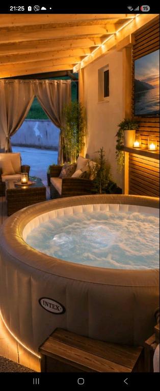 a large jacuzzi tub in a living room at Vikendica SUNCE in Banja Luka