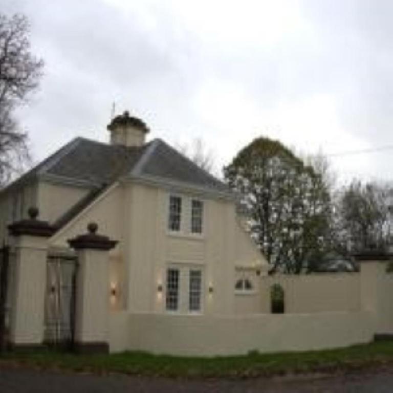 a white house with a chimney on top of it at Hilston Gate House in Skenfrith