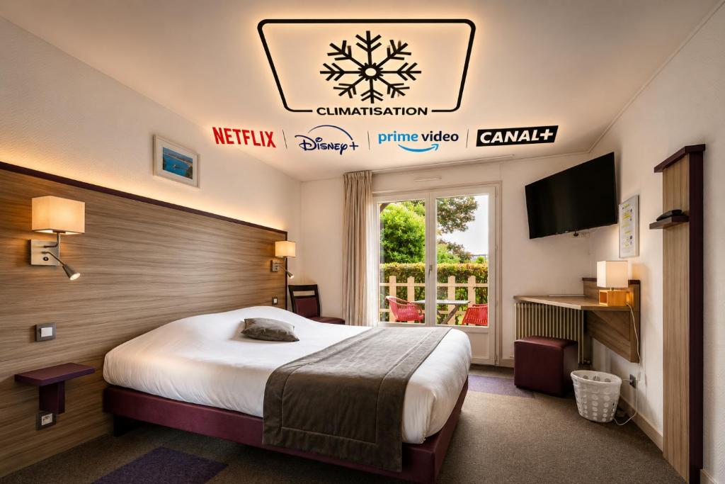 a hotel room with a bed and a tv at Contact Hôtel O'Nice Saintes in Saintes