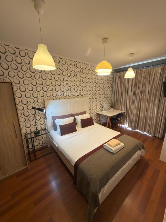 a bedroom with a large bed and two lights at Quarto Bica Central in Lisbon