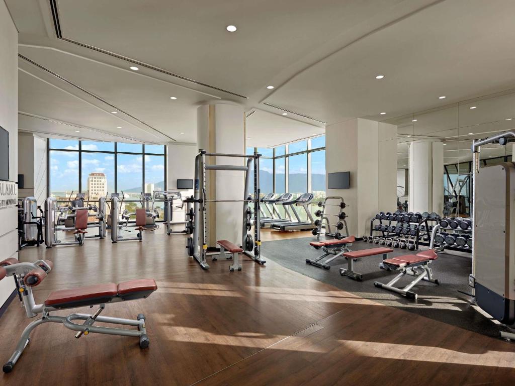 A spacious, window-lined gym with treadmills, free weights and weight machines.