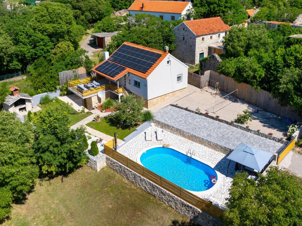 an aerial view of a house with solar panels on its roof at My Dalmatia - Villa Manda Adriatic with Private Heated Pool in Skradin
