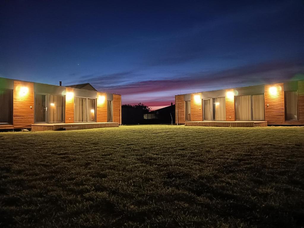 a couple of houses at night with lights at Bianka & Blanka in Poľný Kesov