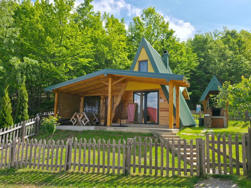 a tiny house in the woods with a fence at Honeywood Cabin II with Private Spa in Bijelo Polje
