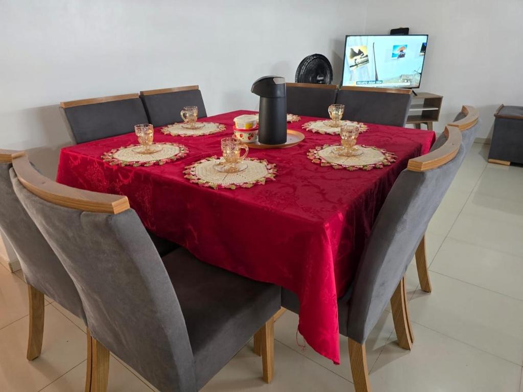 a dining room table with a red table cloth on it at Casa grande perfeita para grupos em Macapá in Macapá