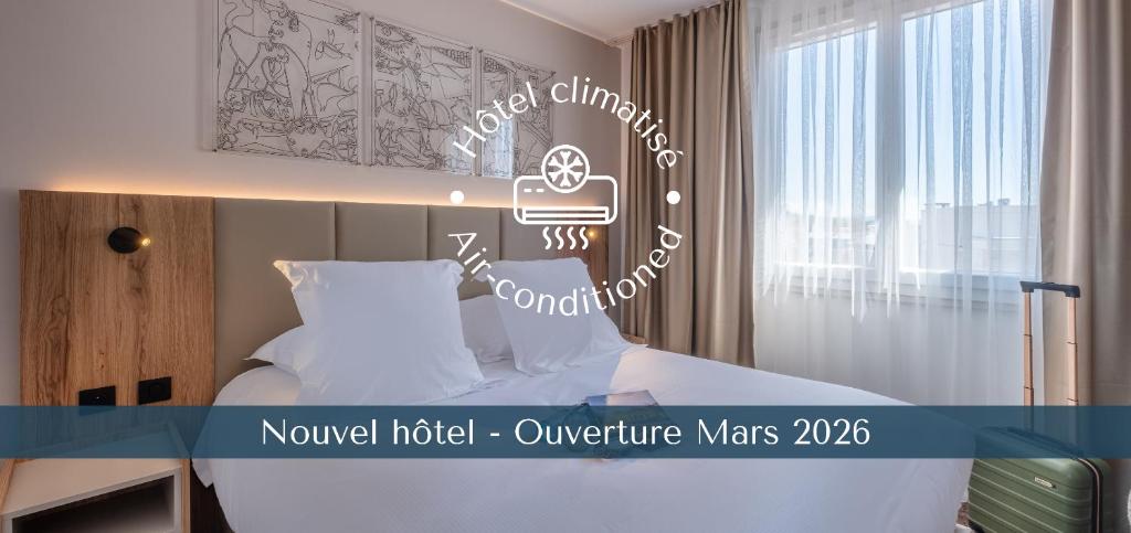 a hotel room with a bed and a sign at The Originals city, Hôtel Harys in Vichy