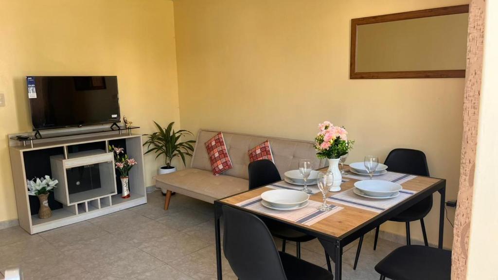 a living room with a table and a couch at Casa Shelter in Chimbote