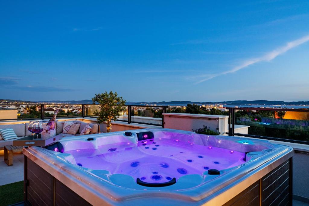 a jacuzzi tub on the roof of a house at Sky Lounge & More - Rooftop Wellness & Gym in Zadar