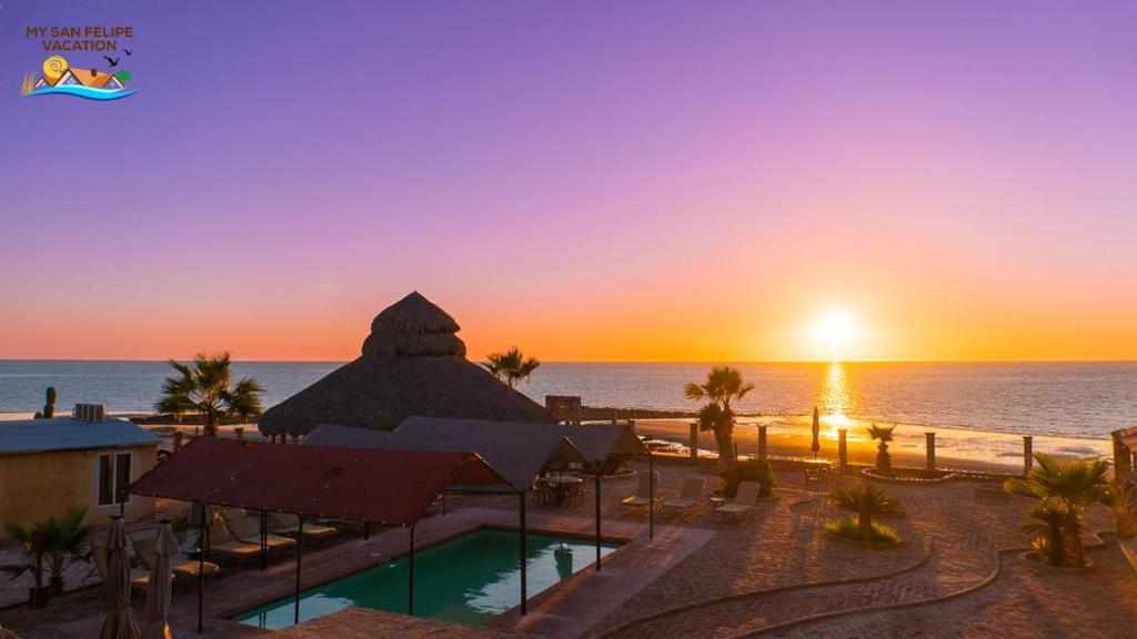 a resort with a pool and the ocean at sunset at Rancho Percebu Beach Studio 5 in San Felipe