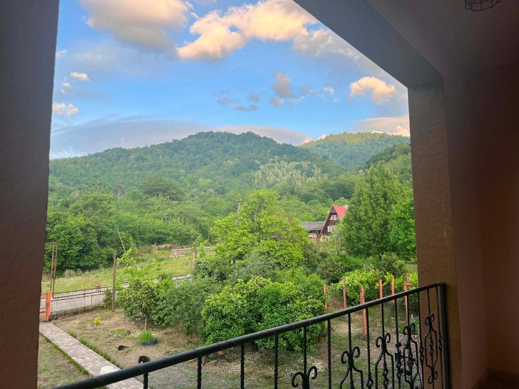 a view of a mountain from a balcony at Likhauri Guesthouse in Likhauri