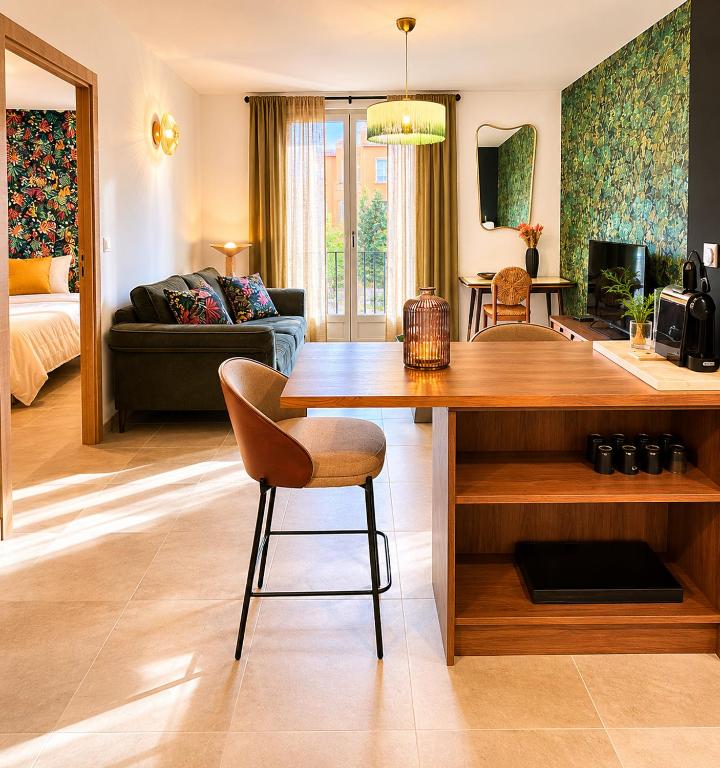 a living room with a dining table and a living room at Superbe Appartement - Centre Calvi - Parking privé in Calvi