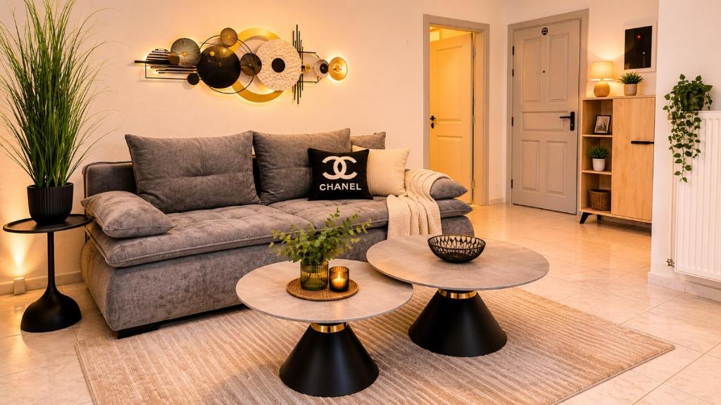 a living room with a couch and two tables at Paralia Sea View Suites in Paralia Katerinis