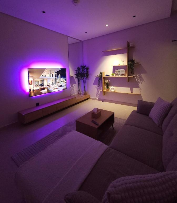 a living room with a couch and purple lighting at شقق عبادي مميزه 1 in Dammam