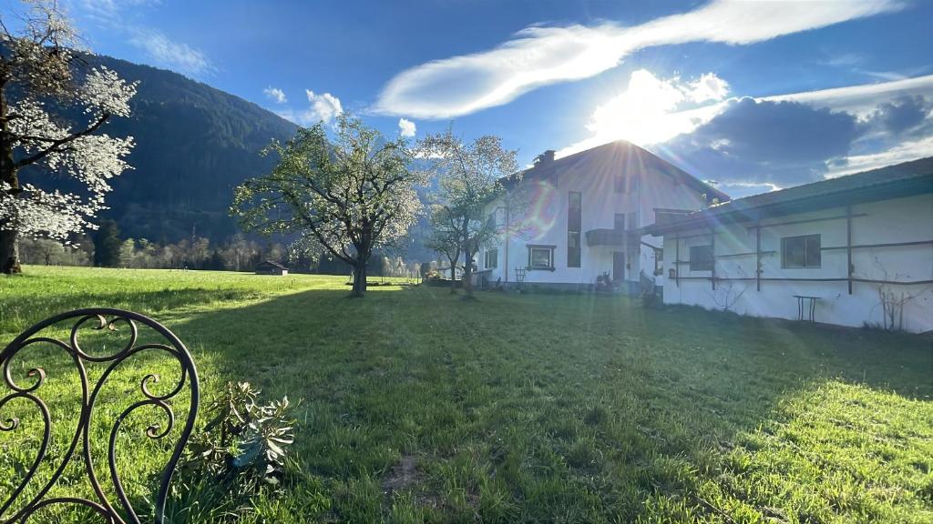 a house in a grassy field with a bench at Whiteberg Apartment in Schruns