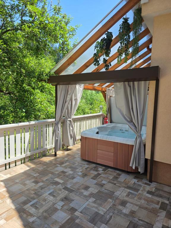 a bed on the deck of a house at Apartment Jurček with jacuzzi & sauna in Luče